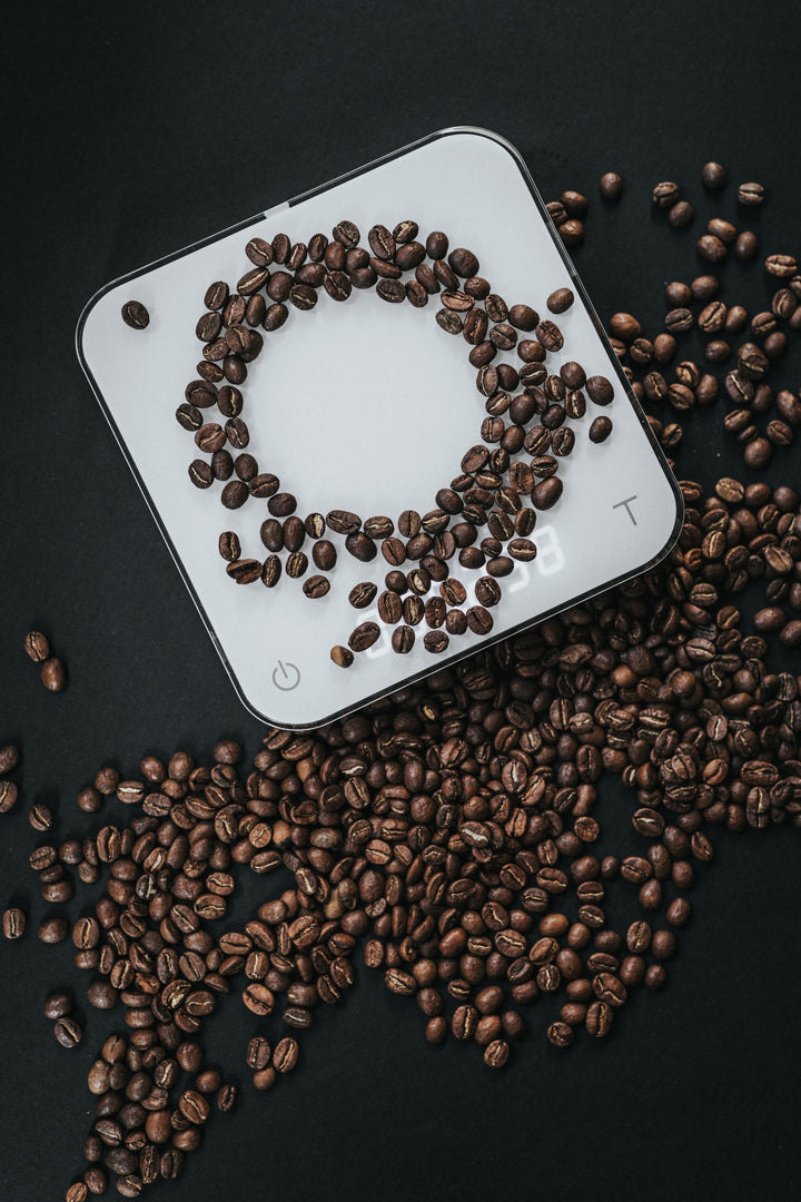 Acaia Kaffeewaage in weiß mit Kaffeebohnen